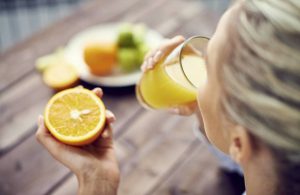 woman-drinking-fresh-orange-juice